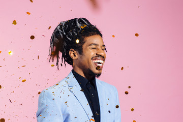Portrait of an elegant man with cool hair and falling confetti	