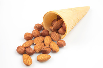 Different nuts in a waffle basket on a white background. Vitamin wholesome food.
