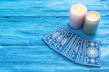 Blue tarot cards deck on blue wooden table background. - obrazy, fototapety, plakaty