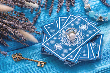Blue tarot cards deck on blue wooden table background. - obrazy, fototapety, plakaty