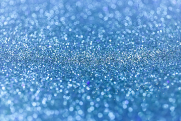 Abstract glitter shining lights background. De-focused lights