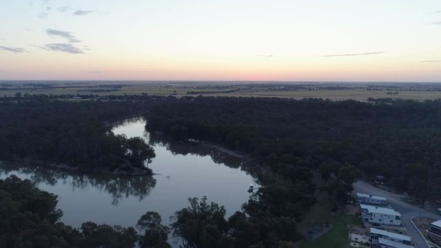 Aerial descend over Murray River bend at sunset in Australia