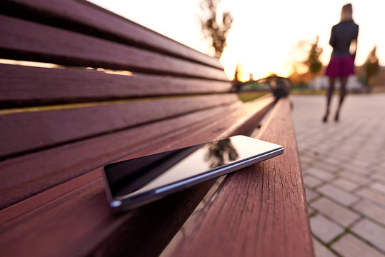Forgotten smartphone on a park bench.