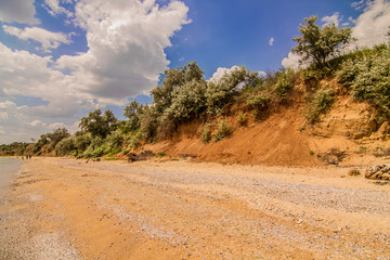 Clay orange cliffs over the sea empty promenade.