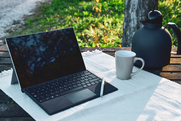 laptop with cup of coffee on wooden table