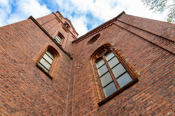 Obraz premium Old large windows in the church. Stained glass windows in a brick building - Central Europe.