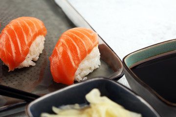 close up of sashimi sushi set with chopsticks and soy - sushi roll with salmon and sushi roll with smoked eel