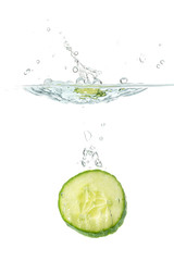 Sliced cucumber splashing water isolated on white background. Skin moisturizing cosmetics