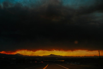 Fototapeta na wymiar Road Trip during wildfires on the horizon in Arizona. Climate change, wildfires, dramatic views.