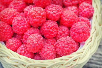 Red raspberries. Healthy and tasty food. Raspberry close-up on the table. Ripe red berry. Raspberries in basket on the table.