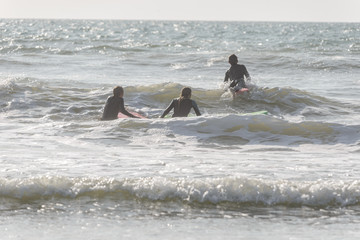 group of surfers in action during summer