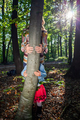 woman and little girl hands hugging a tree - fight climate change, save planet earth for our children