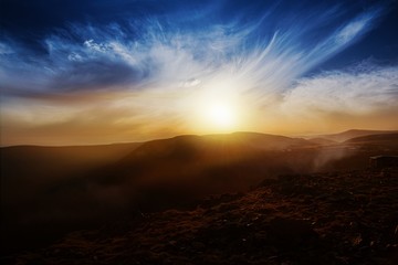 Stormy mountains landscape . Sun light through violent storm clouds. Weather in peas