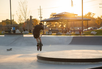 unknown biker does a trick on his bmx bike at sunset