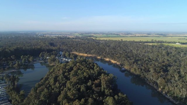 Backward flight over Murray River bend at sunset. Moama, NSW, Australia