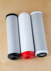 Water filters on a wooden background. New filters for water purification close-up.