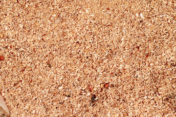 Sawdust or wood dust texture background. Wood sawdust background closeup. Sawdust floor texture. Top view. Saw dust texture, close-up background of brown sawdust.