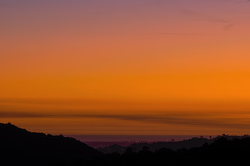 Image of a smoke-polluted dusk sky, following a wildfire,  in Los Angeles looking west. 