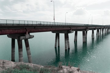 Fototapeta premium bridge over dam water in village