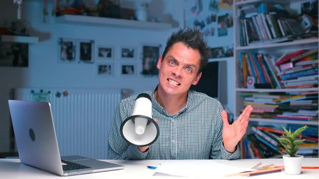 Crazy office worker with a megaphone in his hands.