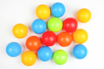 Colored plastic balls on white background