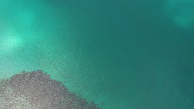Aerial top view of ocean waves, beach and rocky coastline and beautiful forest. Beautiful nature background. island background and tropical with tourist. footage video 4k format. famous island.