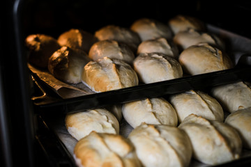 Baked pies on a tray in the oven