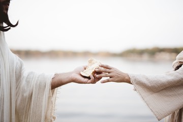 Biblical scene - of Jesus Christ handing out bread with a blurred background