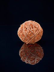 Balls of colored thread on the surface of the glass.On dark background