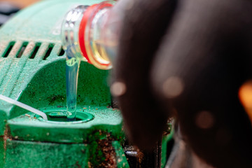 Professional technician working by repair service.Repairing chainsaw in repair shop.