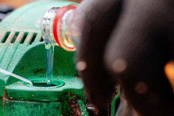 Professional technician working by repair service.Repairing chainsaw in repair shop.