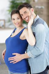 Fototapeta premium woman and man hugging pregnant belly