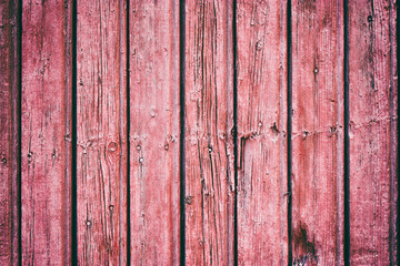 Painted old wooden wall. Red background. Vertical direction of the boards.