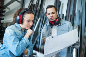 two factory workers with documents