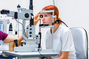 Teenage girl with red hair gets laser eye coagulation