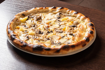 Cheap pizza with mushrooms, pineapple, and corn.
