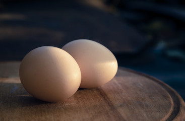 Two egg lay on the wooden table, Soft focus. Close-up two egg lay on the wooden table