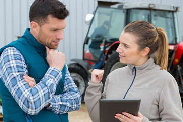 Fototapeta premium two agronomists with laptop and tablet in wheat field