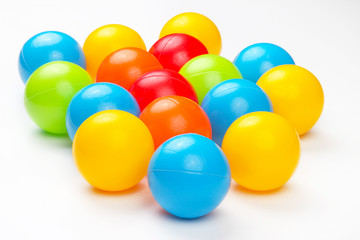 Colored plastic balls on white background