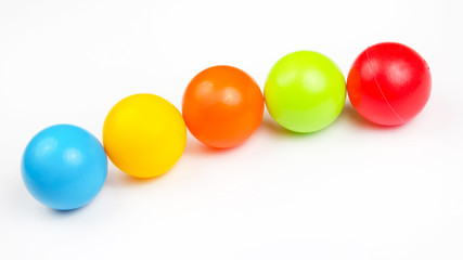 Colored plastic balls on white background