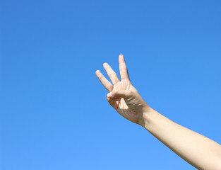 woman hand on blue sky background