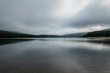 Fototapeta na wymiar Lake, mountains and grey sky