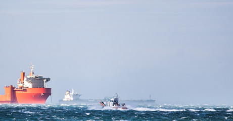 Coast Guard in storm and heavy wind . In background Miramar Castle