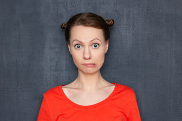Portrait of surprised perplexed girl looking like stupid user