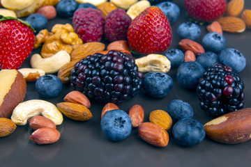 different berries and nuts on a plate. vitamin proteins and healthy foods