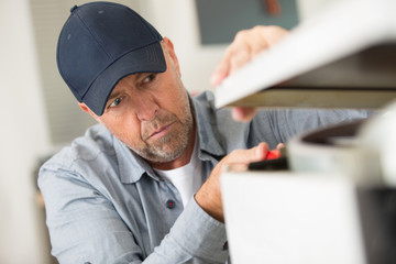 male technician checking electric device