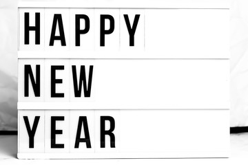 Happy New Year displayed on a vintage Lightbox. Flat Lay Concept image