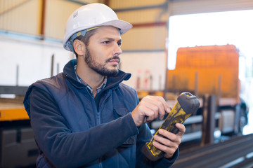 building crane operator with remote control in his hands