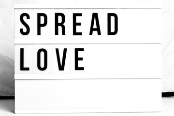 Inspirational Spread Love quote on vintage retro board. Concept. flat lay