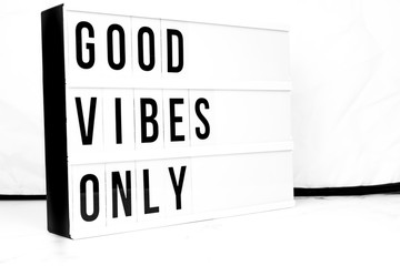 Inspirational Good Vibes Only quote on vintage retro board. Concept
